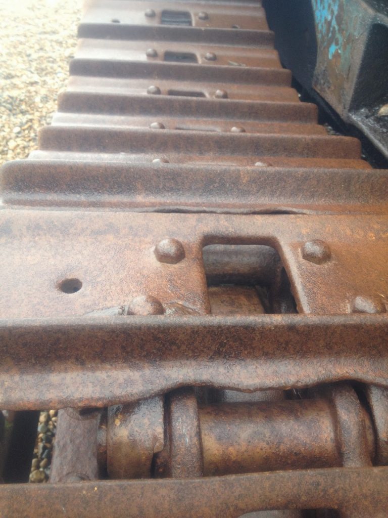 Rust on the beach - metal tractor tracks