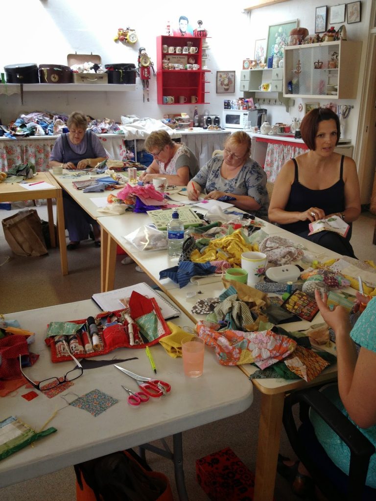 Students rummaging in the fabrics, designing and stitching