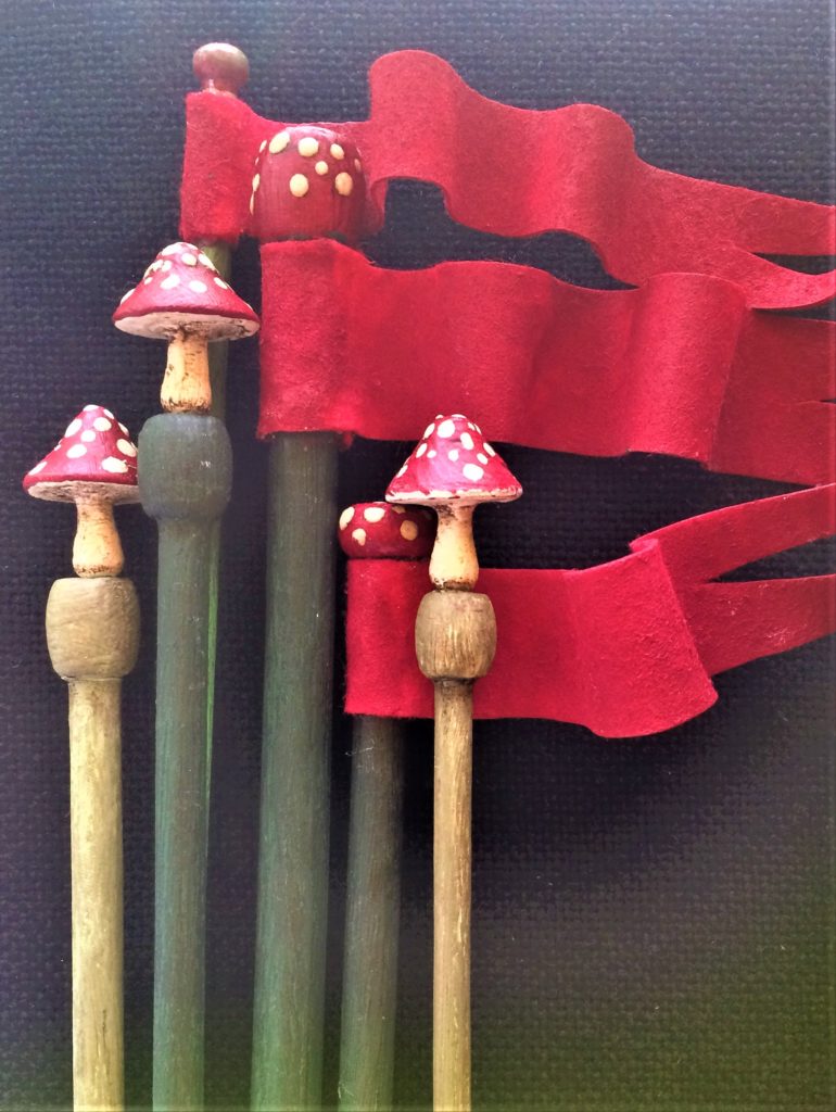 Mr Finch - Tiny toadstools gently sit on the ends of hand painted knitting needles. 