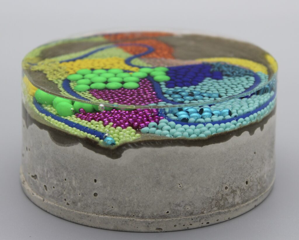 'Substratum' - beaded art set inside resin and concrete -  created by Claire Edwards