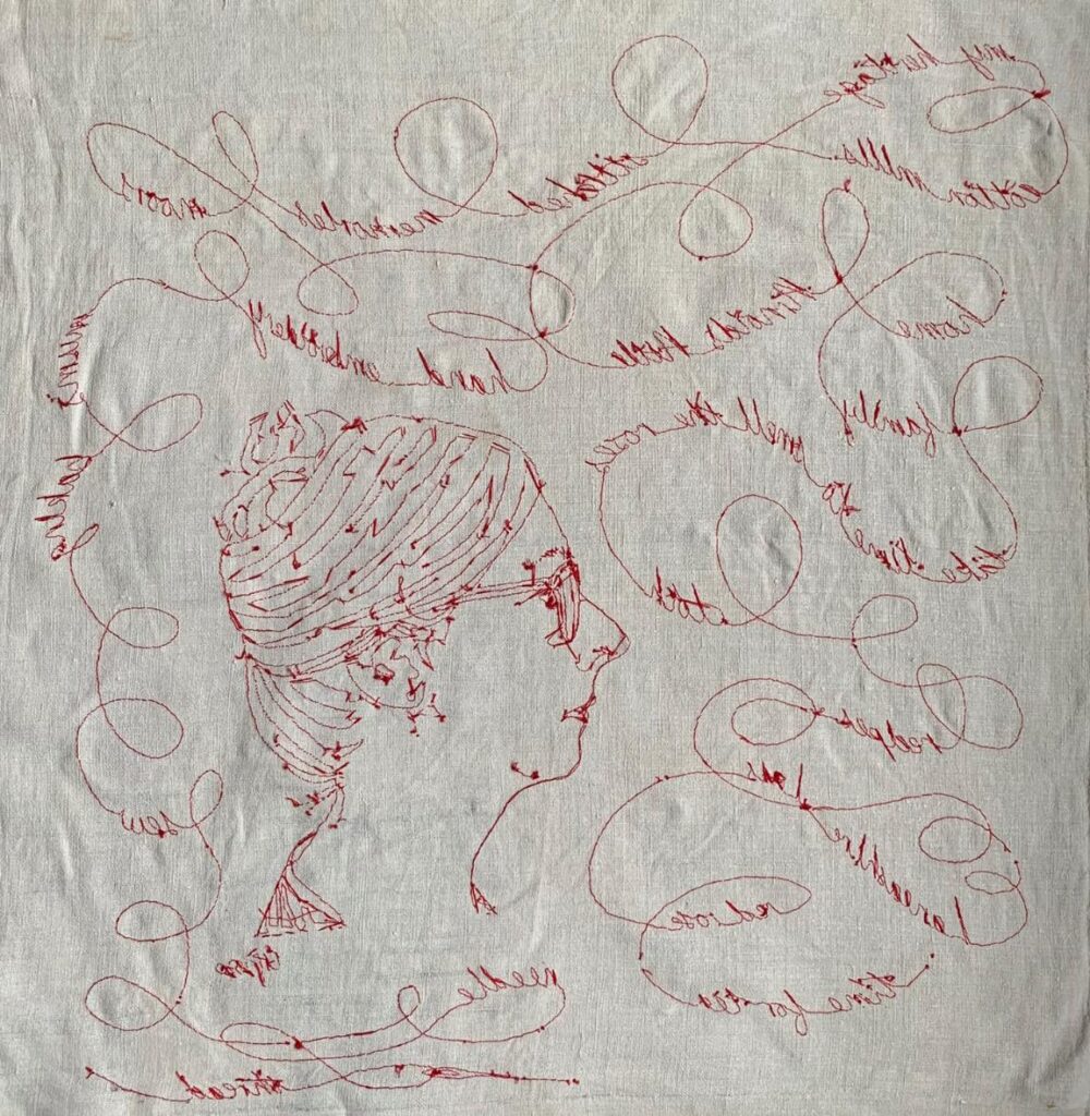 Hand embroidered  red thread in couching stitch.