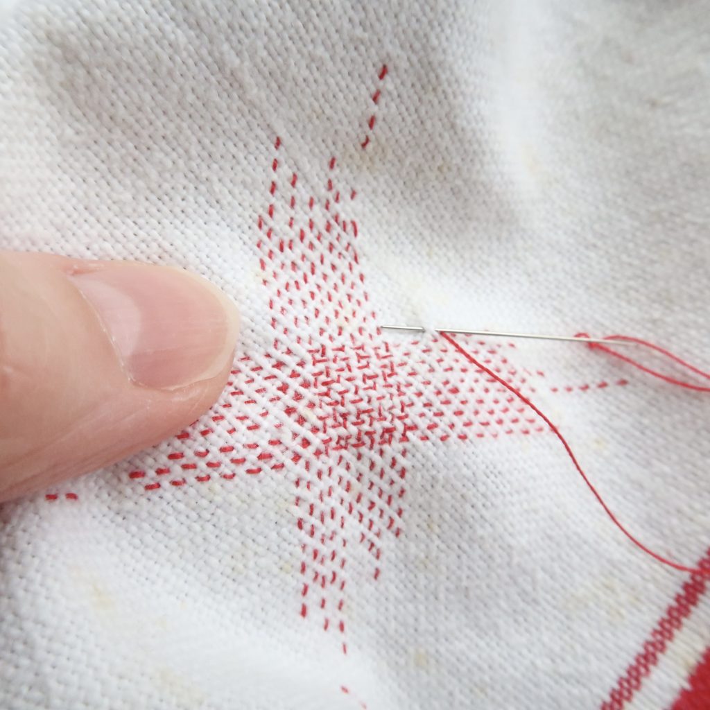 The act of repairing worn and damaged cloth often involves patching, mending and darning. 